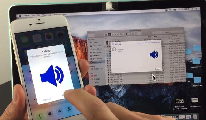 Prikaz delovanja aplikacije AirDrop za deljenje datotek med Applovimi napravami. V konkretnem primeru sta to pametni telefon iPhone (levo) in prenosni računalnik MacBook Pro (v ozadju). | Foto: YouTube