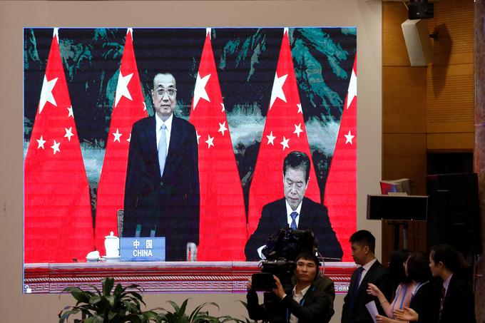 Kitajski minister za trgovino Žong Šan stoji ob premierju Li Keqiangu med podpisovanjem sporazuma. | Foto: Reuters