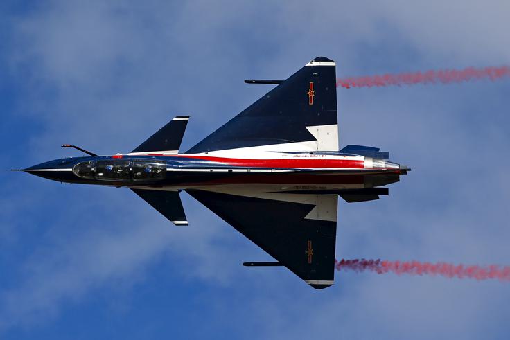 Akrobatska formacija Bayi z lovci J-10 predstavlja kitajski TOP GUN, v katerih letijo najboljši piloti Kitajske ljudske osvobodilne armade. V Zhuhaiju so kitajski piloti sicer gostili tudi britansko akrobatsko formacijo, znano kot Red Arrows oziroma Rdeče puščice.  | Foto: Reuters