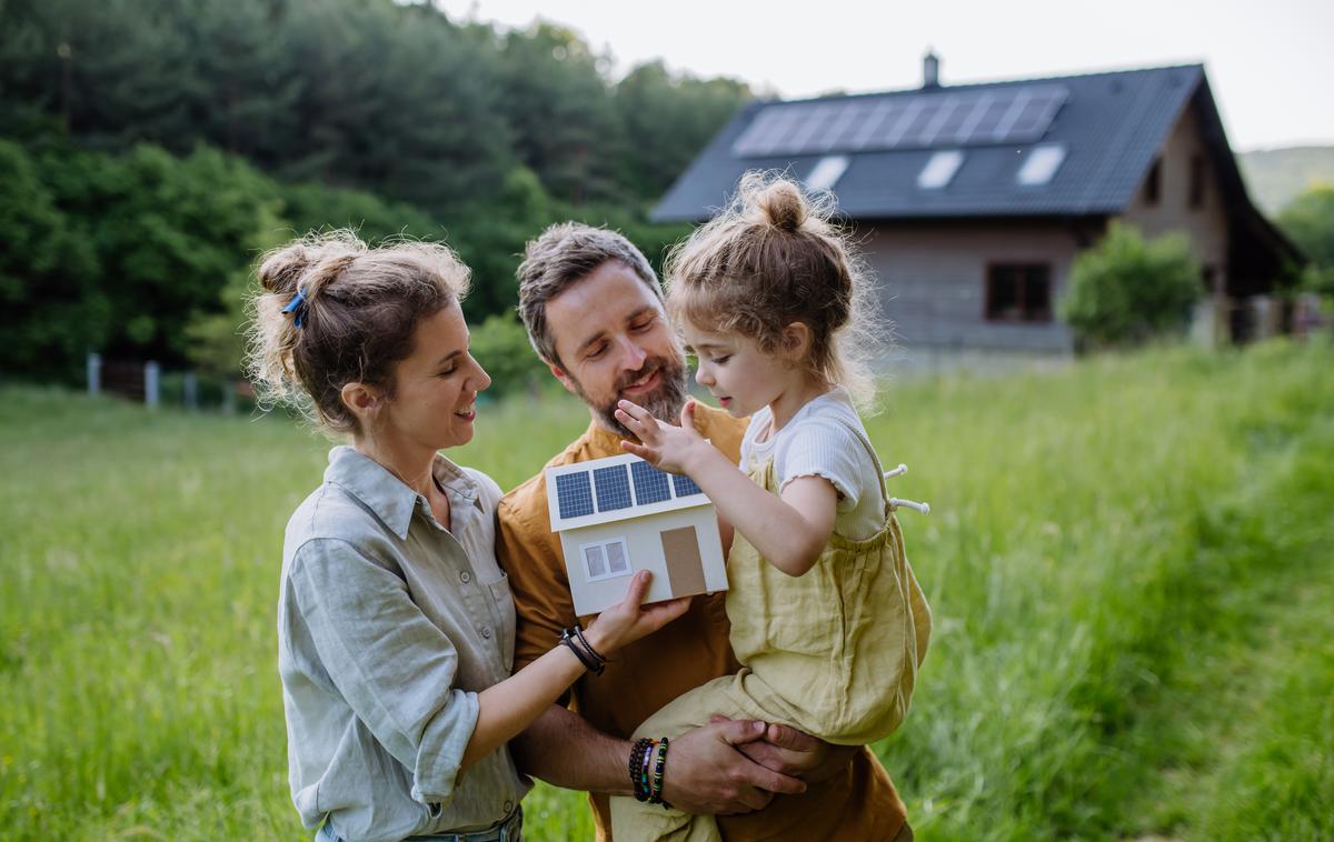 družina pred hišo s sončnimi paneli | Foto Shutterstock