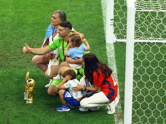 Po tekmi je poziral z nagradama, zlato rokavico in pokalom za svetovnega prvaka, z družino. | Foto: Reuters