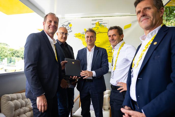 Tour de France Robert Golob | Robert Golob je pred štartom zadnje etape dirke v kraju Mantes-la-Ville direktorju dirke Christianu Prudhommu predal pismo o nameri za organizacijo izvedbe dogodka veliki start Dirke po Franciji v Republiki Sloveniji za leto 2029. | Foto Vlada Republike Slovenije