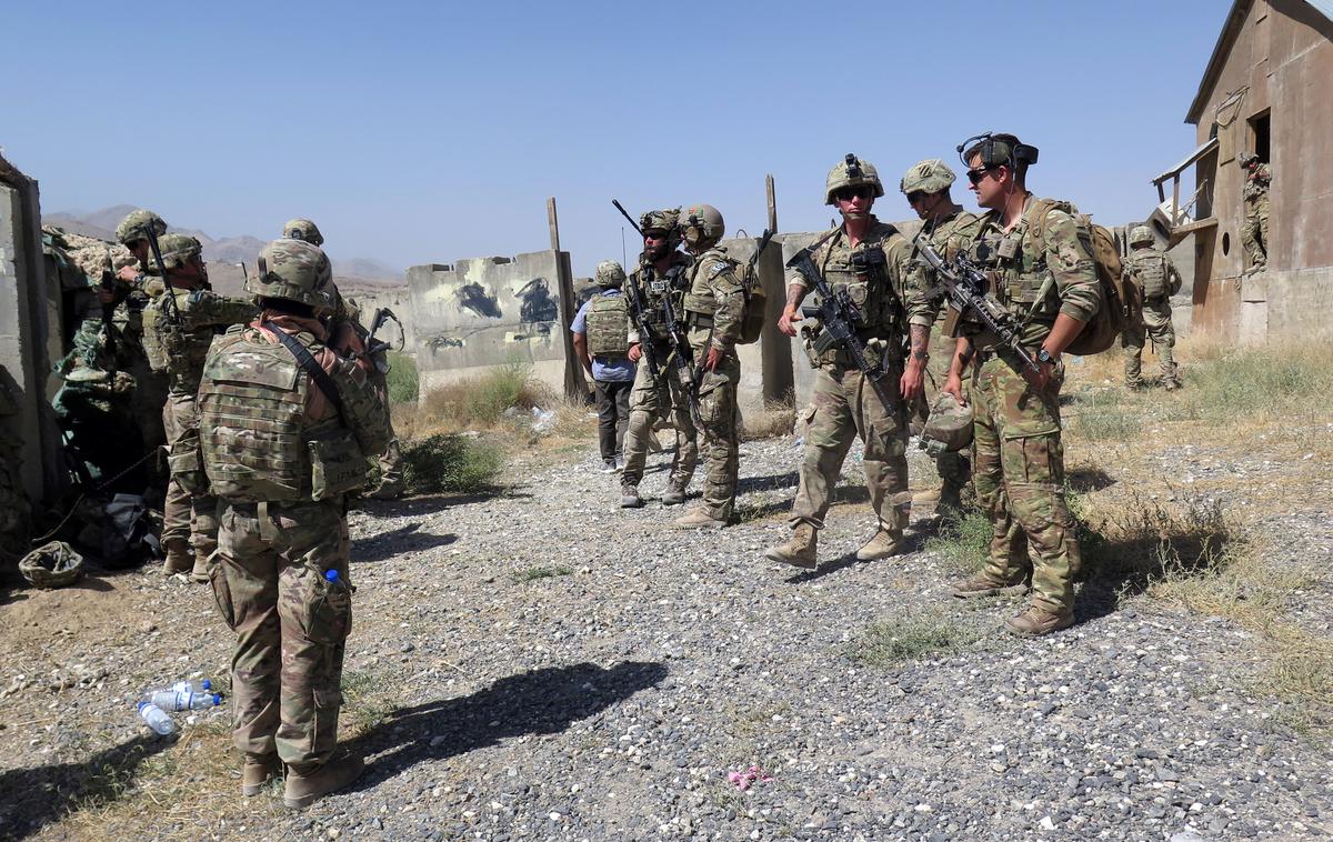Ameriški vojaki v Afganistanu | Koalicija pod vodstvom ZDA je včeraj sporočila, da je začasno ustavila aktivnosti v boju proti IS v Iraku, kjer ameriške sile urijo lokalne vojake. Kot razlog je navedla dejstvo, da so zeleno cono v Bagdadu, kjer je med drugim ameriško veleposlaništvo v Iraku, ter oporišče, kjer so nameščene ameriške sile, v soboto zadele rakete. | Foto Reuters