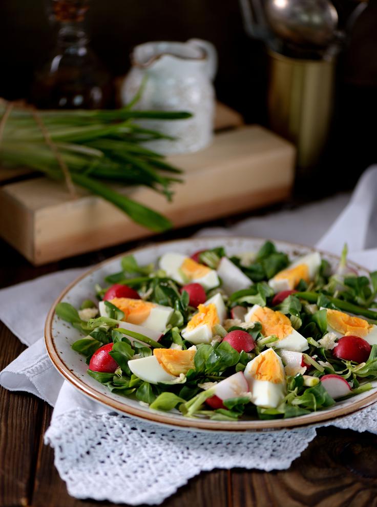 Spomladanska solata z narezanimi kuhanimi jajci, rukolo, redkvicami in svežo zelenjavo je preprost in okusen način, kako po praznikih porabiti pirhe ter jih spremeniti v lahkotno, barvito jed z dodatkom bučnega olja. | Foto: Shutterstock