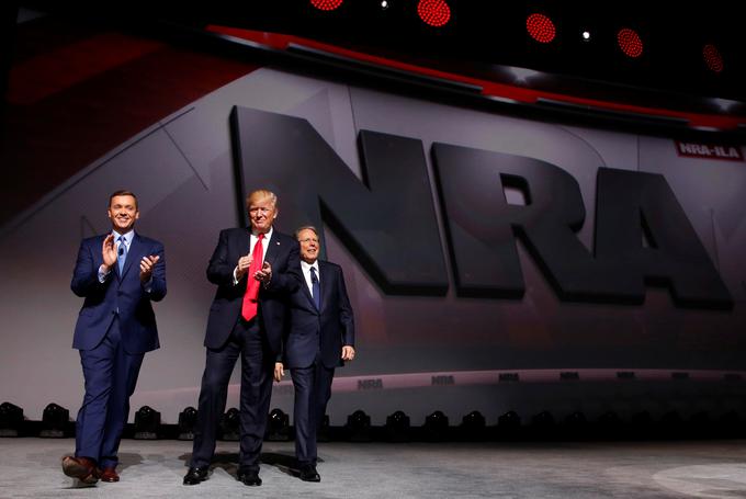 Donald Trump je aprila letos obiskal kongres NRA, kjer sta ga pozdravila vodji organizacije Chris Cox (levo) in Wayne LaPierre (desno). | Foto: Reuters