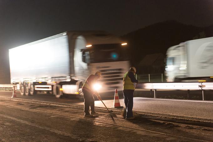 Ponoči je na prvem mestu tudi varnost delavcev, ki stojijo le kak meter od avtomobilov in tovornjakov. Marsikateri voznik ne spoštuje omejitve hitrosti. | Foto: Klemen Korenjak