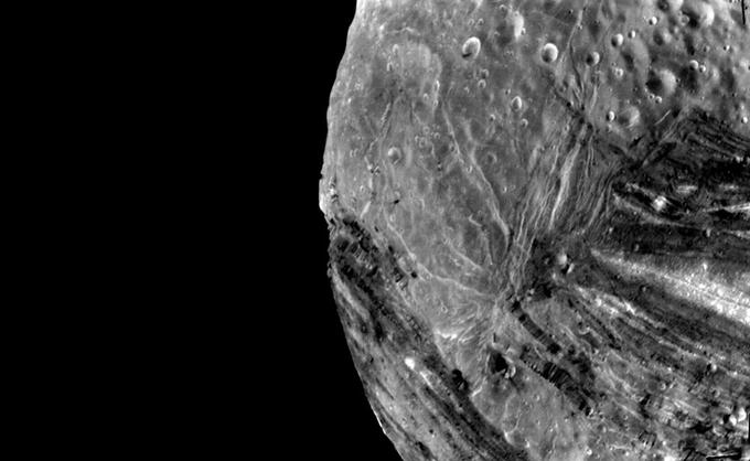 Miranda, luna, ki je najbližje površini planeta Urana, ima enega od najbolj razgibanih reliefov, kar smo jih do zdaj našli v Osončju. Astronomi menijo, da so stene nekaterih kanjonov na Mirandi visoke od pet pa kar do deset kilometrov. | Foto: NASA