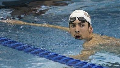 Phelps po olimpijski slavi spet v bazenih