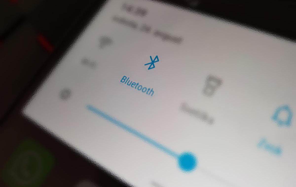 Bluetooth | Bluetooth, ki ga poznamo po modrem simbolu z belo črko B z antenama, je protokol za brezžično povezovanje elektronskih naprav, na primer pametnega telefona s slušalkami. Gre za razmeroma nizkoenergetsko povezavo, zaradi česar bluetooth baterije prenosnih naprav ne obremeni pretirano, a hkrati tudi nima velikega dometa. Povezavo med napravama lahko izgubimo že, če stopimo v drug prostor. | Foto Matic Tomšič