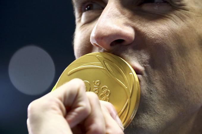 Američan Michael Phelps je osvojil več kot trikrat več zlatih medalj kot Slovenija na vseh zimskih in poletnih olimpijskih igrah skupaj. | Foto: Reuters