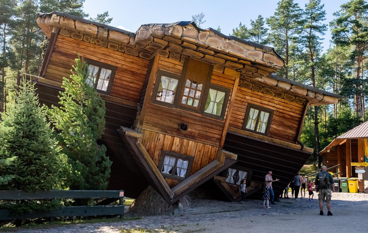 Narobe obrnjena hiša, Poljska | Konstrukcija hiše med obiskovalci povzroča vrtoglavico. Zaradi nenavadne perspektive in nagiba hiše jo številni hitro zapustijo. | Foto Profimedia