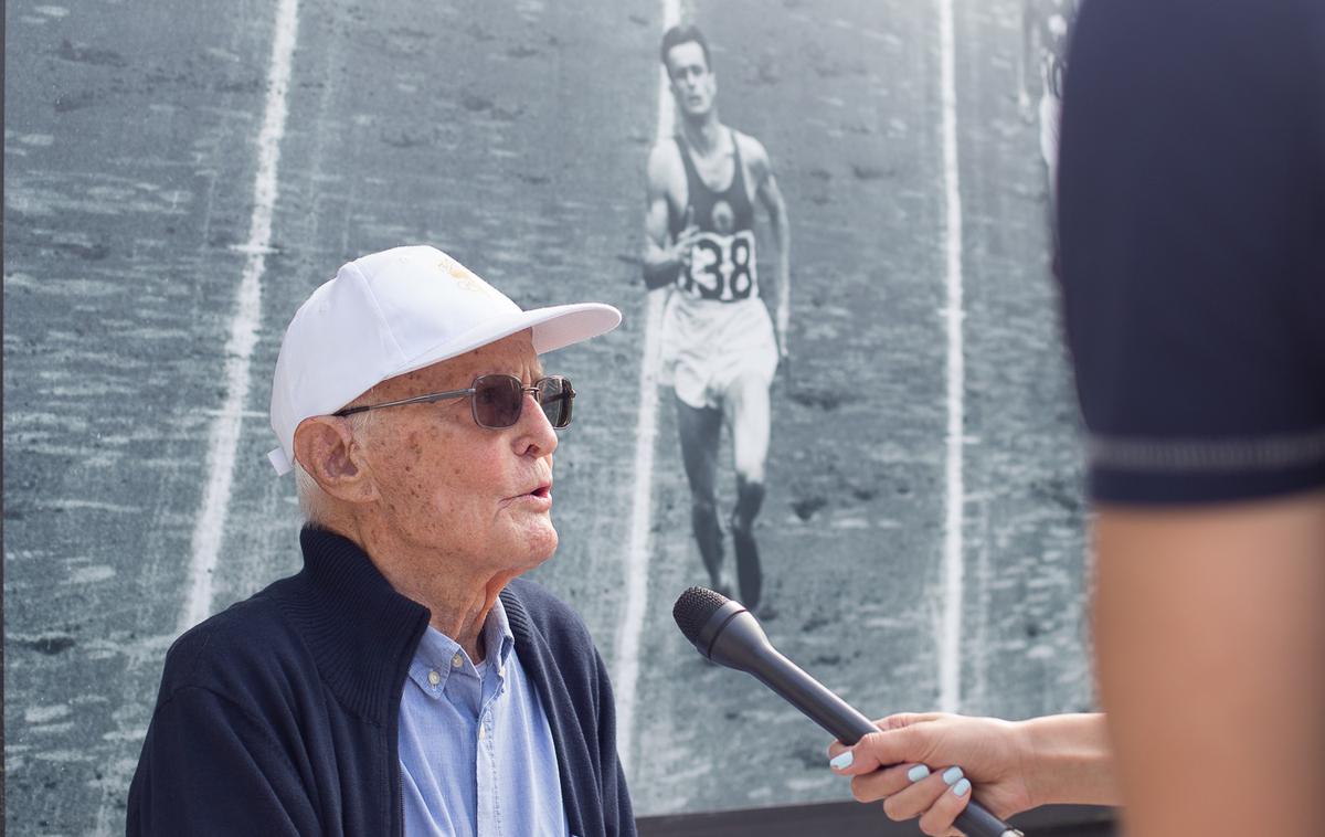 AZS sto let | Stoletni Martin Račič ob svoji fotografiji z olimpijskih iger leta 1948, ki jo lahko najdete na razstavi ob stoletnici slovenske atletike. | Foto Peter Kastelic/AZS
