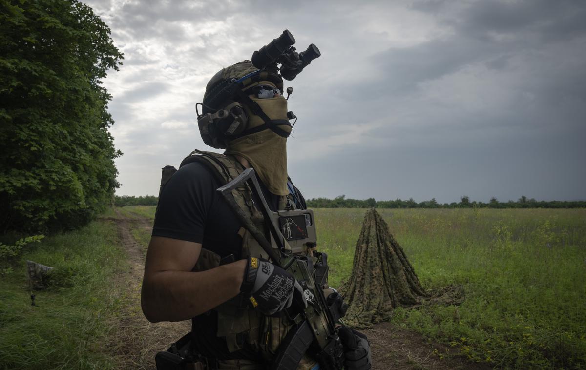 Ukrajinski vojak | Ukrajinski vojak na fronti v južni ukrajinski regiji Zaporožje opazuje nebo, da bi odkril morebitne drone. Fotografija je bila posneta 24. junija letos. | Foto Guliverimage
